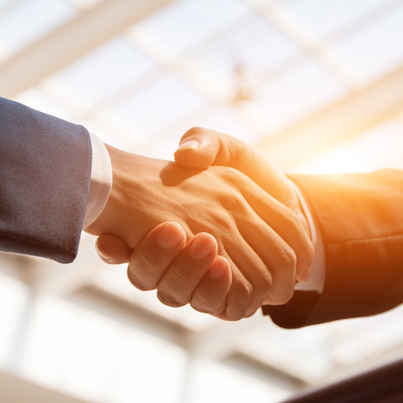 Nissan of Lexington Park in California MD customer shaking hands with sales rep