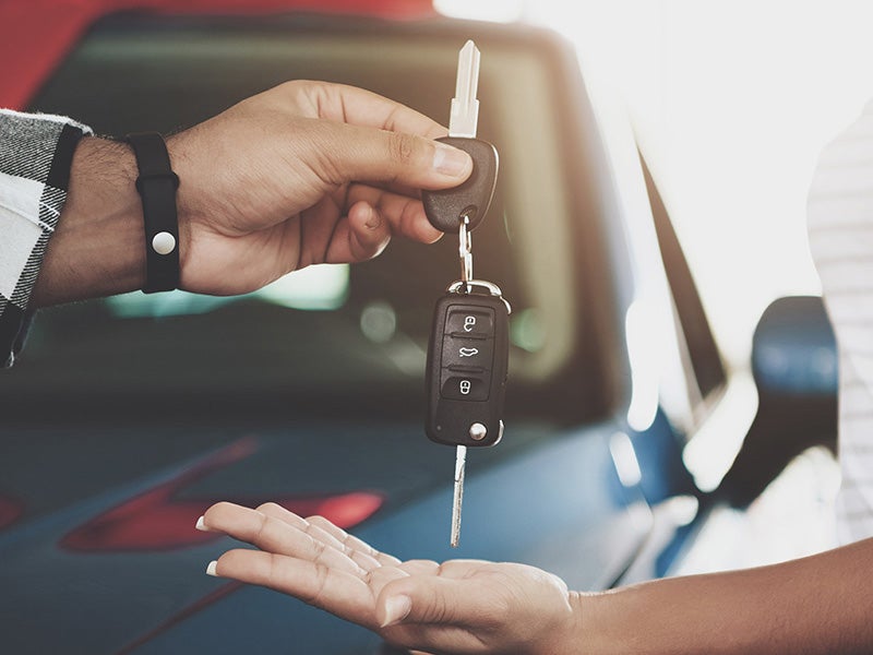 Nissan of Lexington Park in California MD customer handing over keys to their car