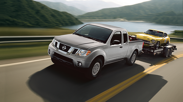 Nissan of Lexington Park in California MD pickup truck pulling a trailer in front of a lake