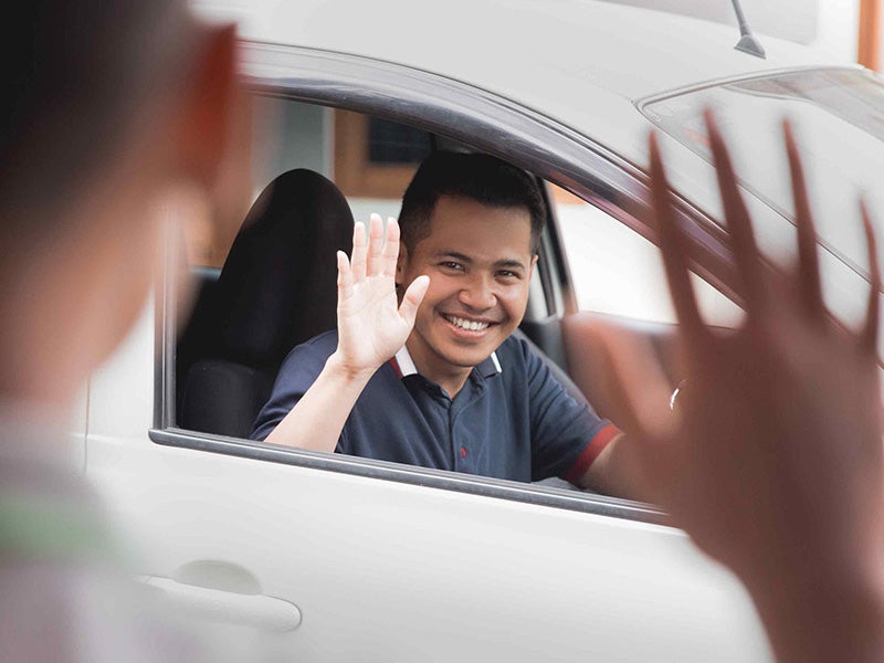 Nissan of Lexington Park in California MD customer waving to sales rep